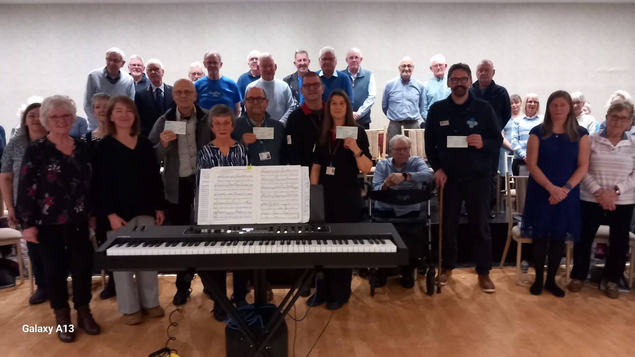 Felixstowe Community Choir presents four charity cheques, bringing the total they have raised since they began in 2013 to £43,900
